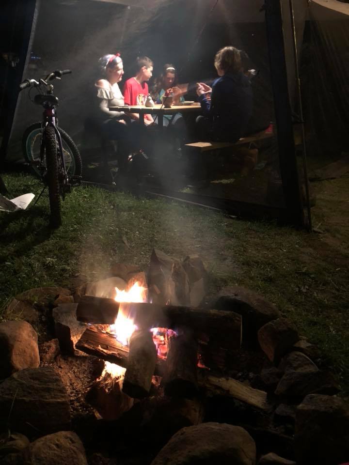 several youth enjoy a friendly game of apples to apples